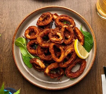 Golden crisp fried calamari rings served with house spicy mayo dip at Epicurean Singapore