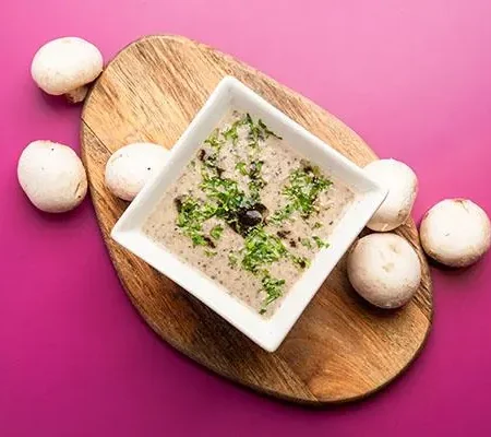 Creamy homemade truffle mushroom soup served with toasted artisan bread at Epicurean